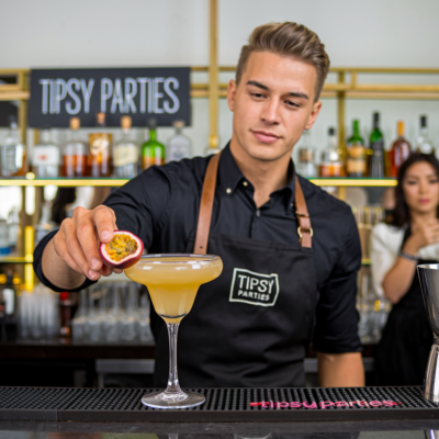 image showing a bartender adding a garnish to a cocktail